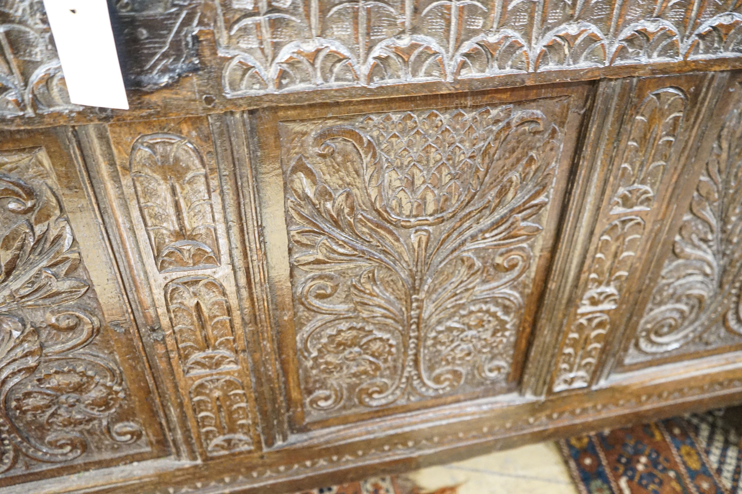 A large 17th century foliate carved oak coffer, length 159cm, depth 72cm, height 76cm